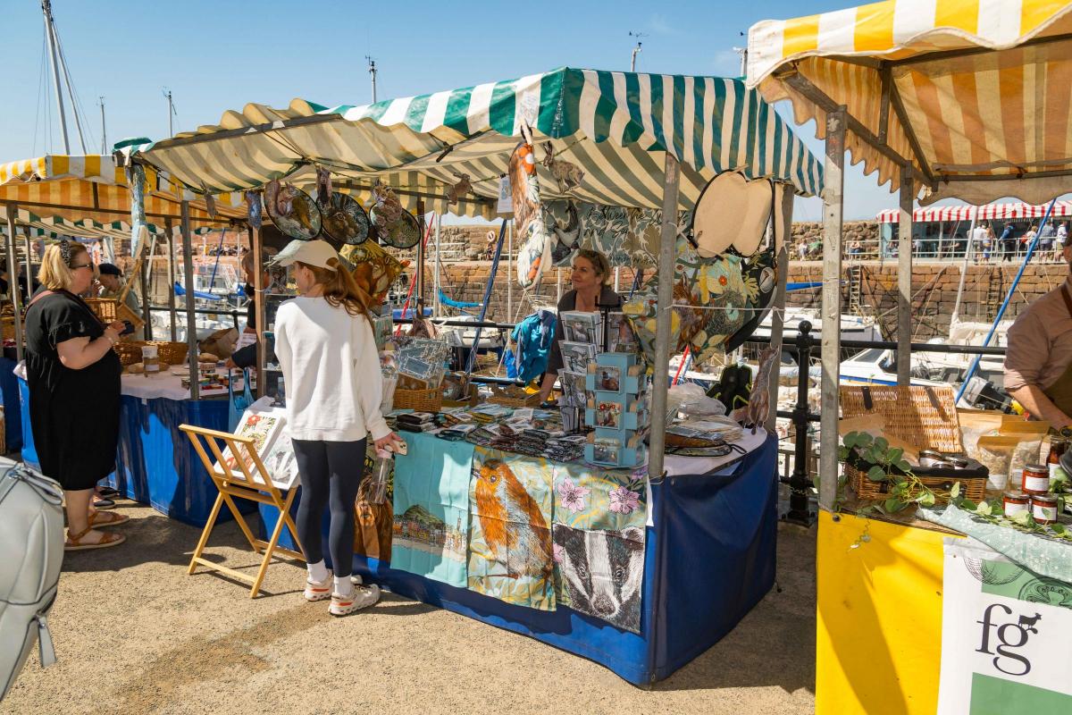A crowded market spilling along the harbour front